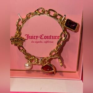 Juicy Couture Gold Charm Bracelet with Red and Purple Gem Accents
